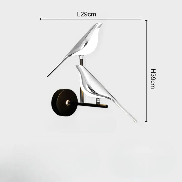 Applique murale Luminaire Essenza avec interrupteur LED rotatif 360°, design oiseau double argent et blanc naturel.